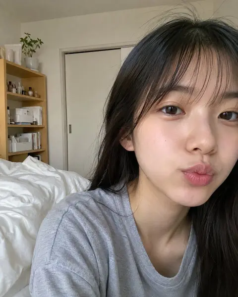 A 22-year-old Japanese woman takes a selfie of pure life in the bedroom in the morning