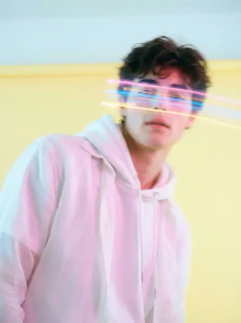 A dreamy Korean boy painted with pastel light tracks