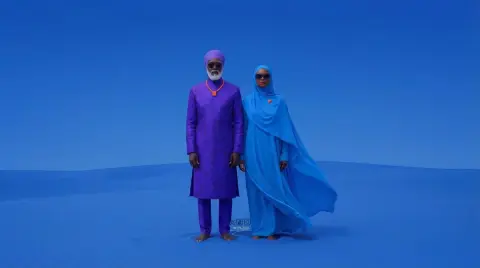 African future elders standing in the silent desert under the cobalt blue sky