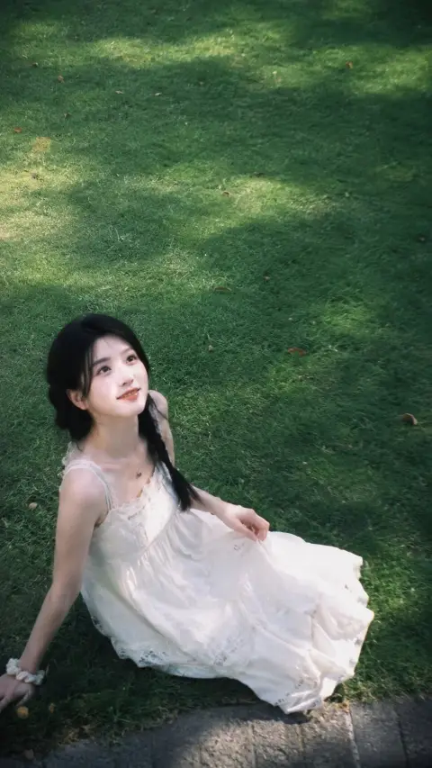 An overhead photo of a pure Korean girl on the grass