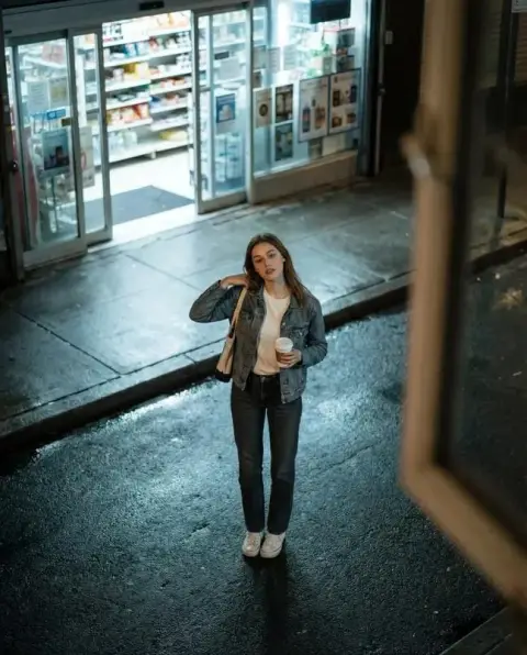An overhead shot of a girl in a convenience store at night