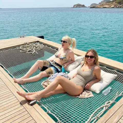 Best friends summer time on a wooden boat in the Mediterranean