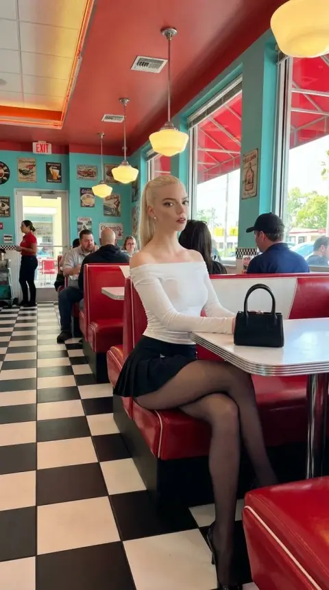 Blonde fashionable beauty in retro restaurant