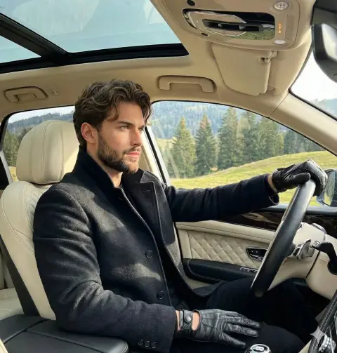 Calm and confident young gentleman inside luxury SUV