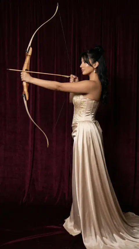 Champagne satin archer under burgundy red curtain