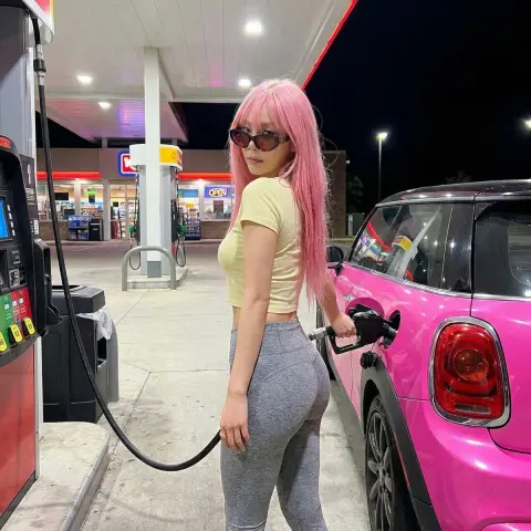 Charming look back at the busty beauty at the gas station at night