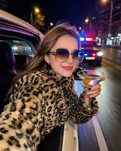 Close-up of luxury fashion lady next to luxury car in neon night