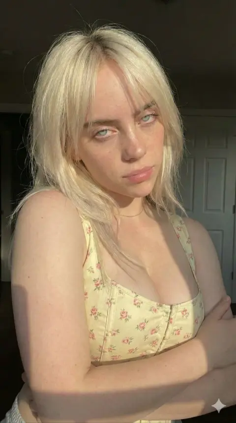 Close-up of blond girl with freckles bathing in golden sunset