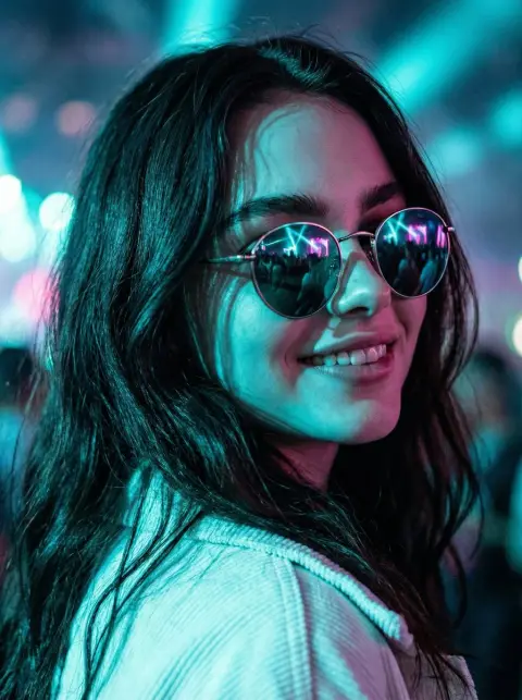 Cool girl wearing reflective sunglasses at electronic music festival