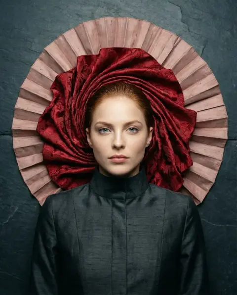 Crimson brocade suspended on dark slate and cool supermodel
