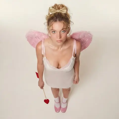 Cupid with pink wings under soft light