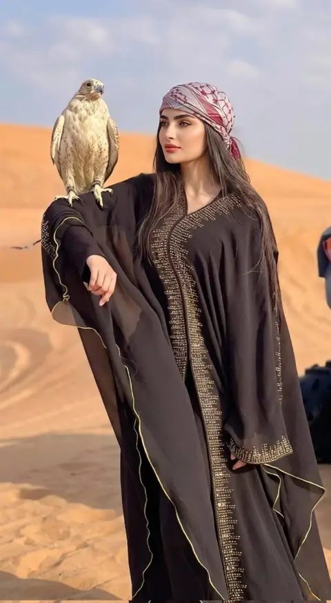 Desert fashion lady and falcon