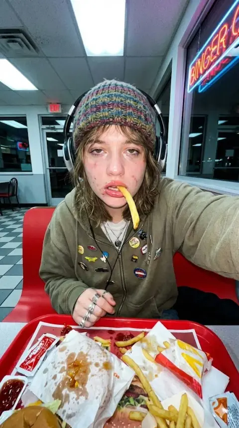 Exaggerated wide-angle French fries selfie at three in the morning