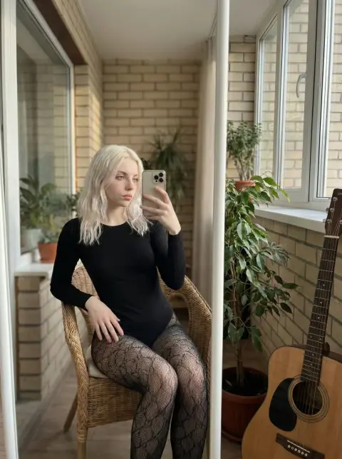 Extremely realistic icy platinum blonde girl fashion selfie in the mirror