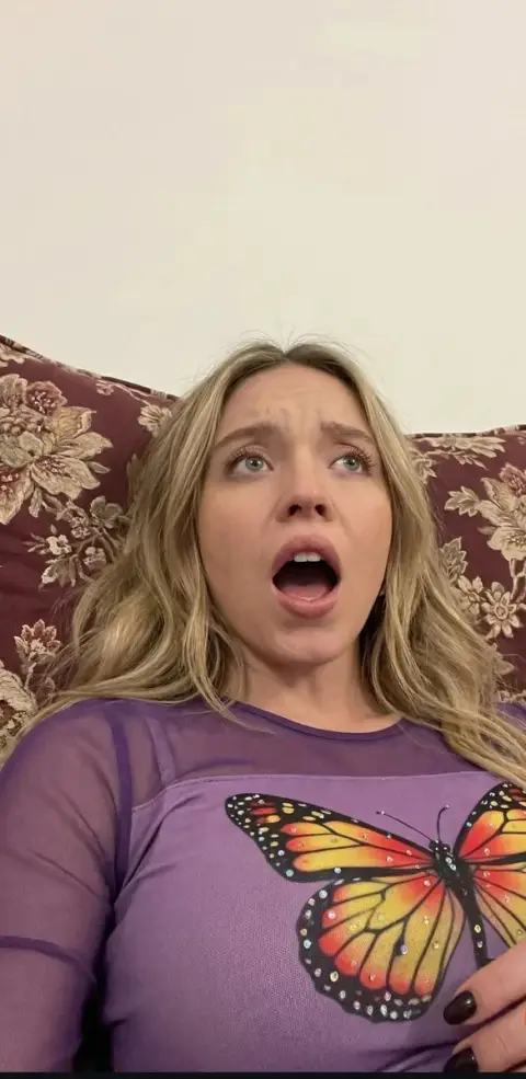 Extremely tense close-up of a surprised blond girl from a perspective shot from above