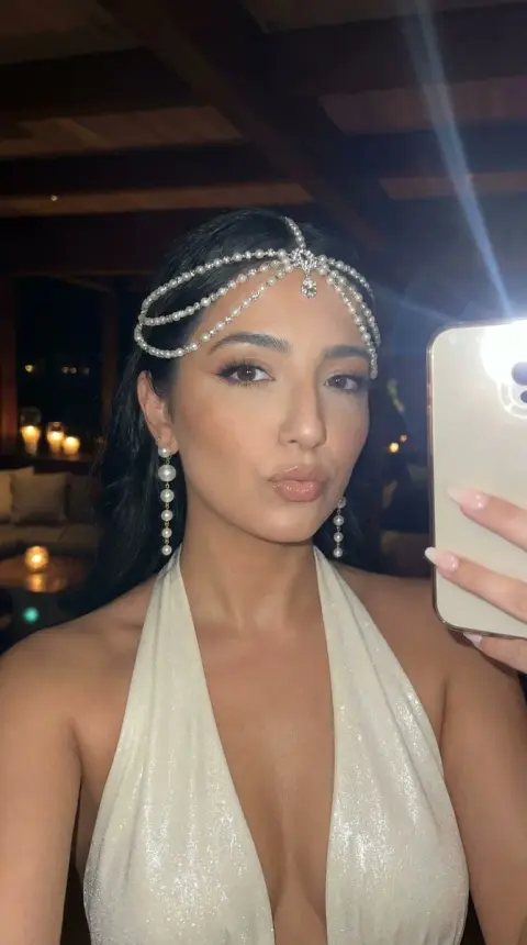 Flash selfie of a girl with dazzling pearls at night