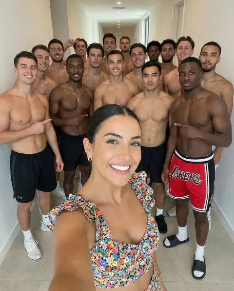 Floral hottie takes a happy selfie with a shirtless boy band