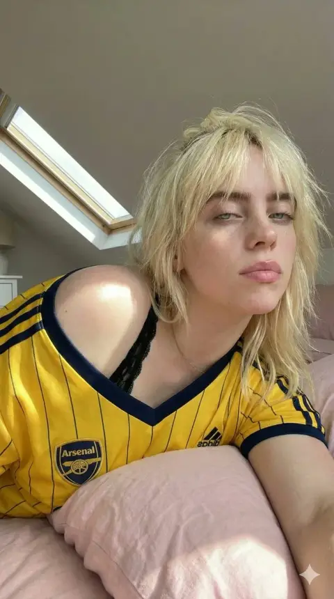 Football girl in yellow shirt under the attic skylight