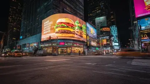 Giant gourmet billboard with neon lights in the rainy night