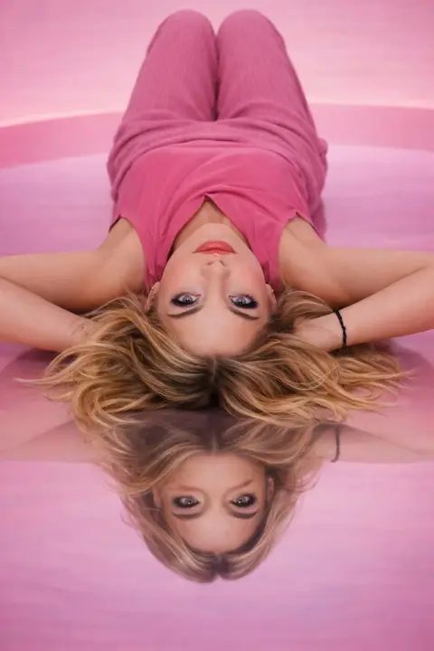 High fashion portrait of a girl in minimalist pink tones