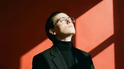 Hyper-realistic portrait of sharp triangle shadow cut by setting sun