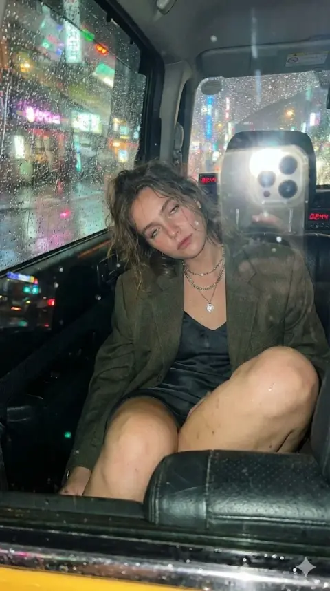 Lazy and charming girl in a taxi on a rainy night