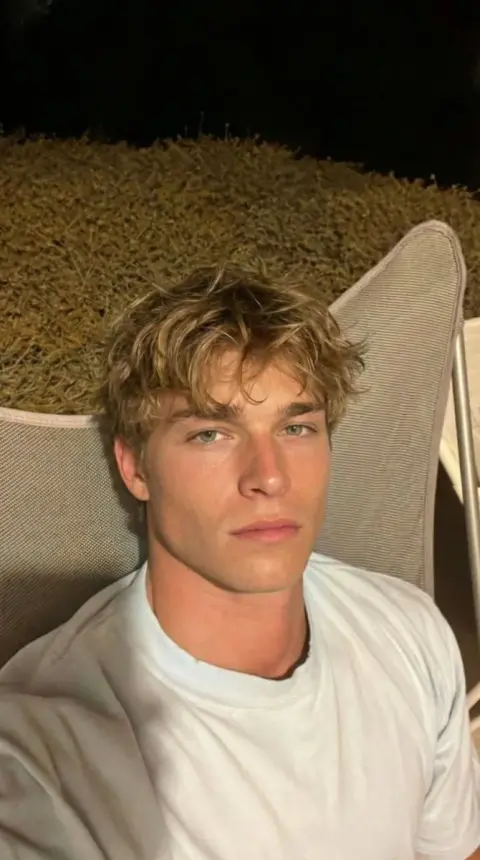 Lazy selfie of handsome blond guy at night