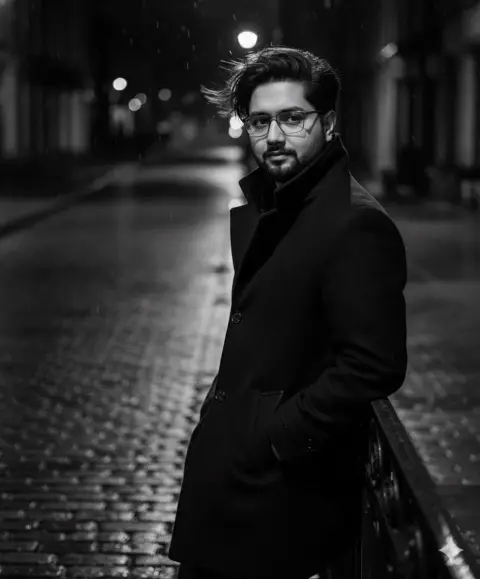 Male model in black-tone trench coat in black and white street style
