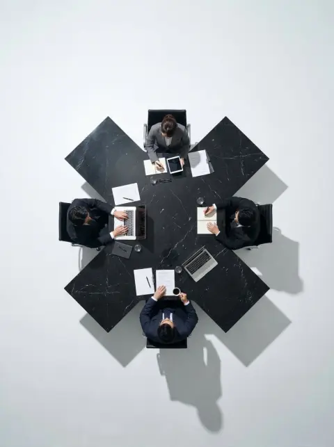 Minimalist overhead view of X-shaped black marble meeting