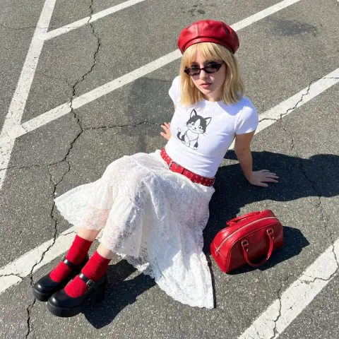 Modern street fashion of blonde girl in red beret