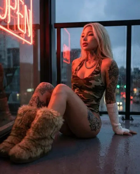 Neon fashion blockbuster of camouflage tattoos on the balcony on a rainy night