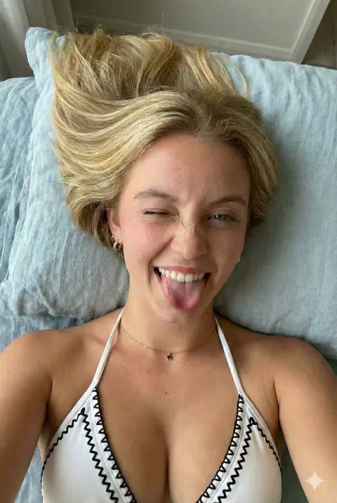 Overhead shot of playful and winking blonde girl