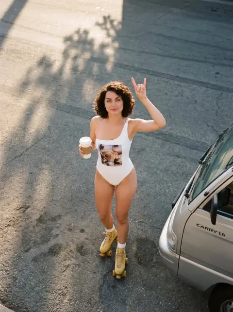 Pink girl holding coffee on the street in summer evening