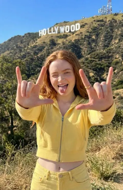 Playful red-haired girl in front of the Hollywood Hills
