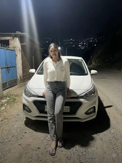 Portrait in front of car under night light