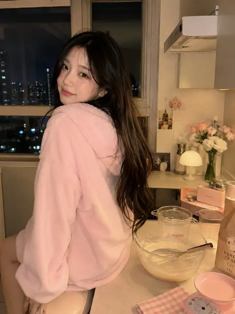 Portrait of sweet baking girl in Korean late night kitchen
