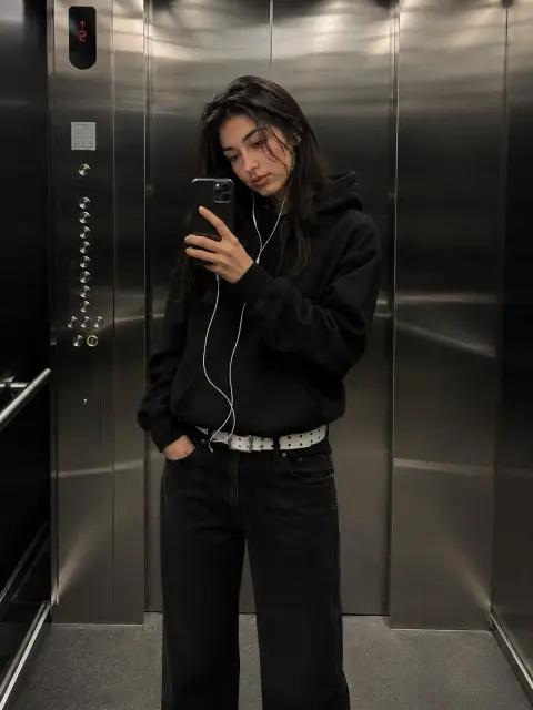 Realistic fashion girl taking selfie in elevator mirror