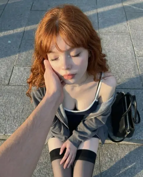 red-haired girl on the street during golden hour