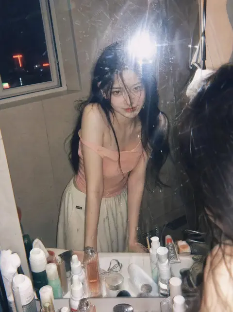Retro film-style portrait of a girl in front of the bathroom mirror