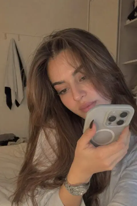 Shy girl recording private video in bedroom