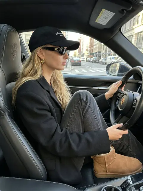 Side view of blond supermodel in Porsche car