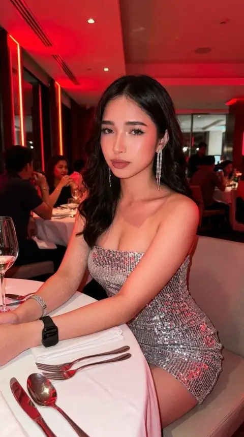 Silver sequined girl under red neon light