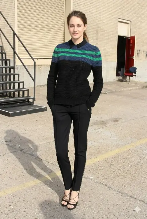 Snap shot of girl in striped sweater against industrial style background