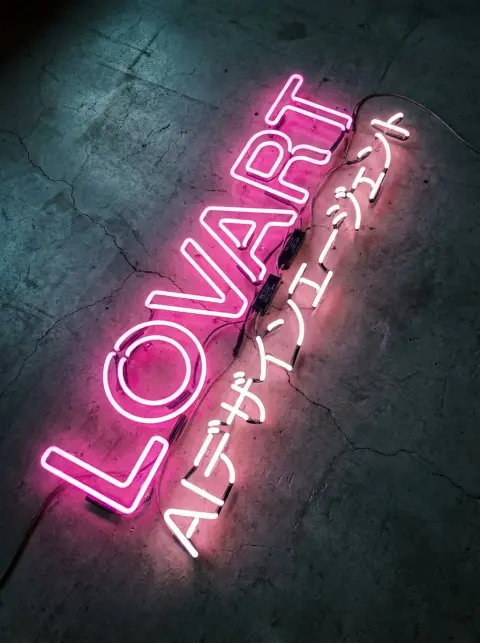Soft pink neon tube art on concrete floor