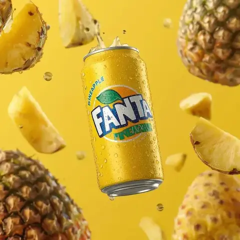 Suspended yellow can of soda and sweet pineapple juice drops