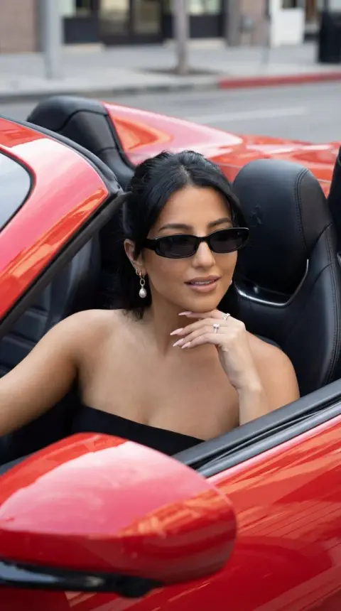 The cool luxury fashion blockbuster in the red convertible sports car