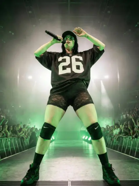 The domineering female singer on the green light stage