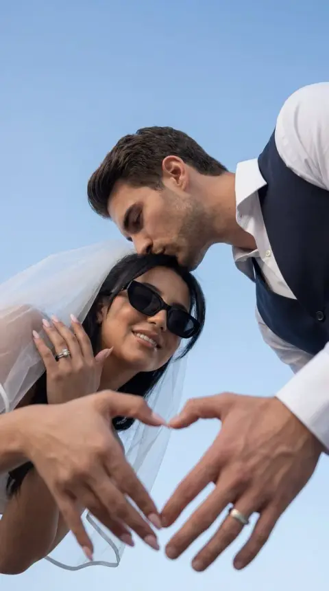 The ultimate romantic wedding moment under the blue sky.
