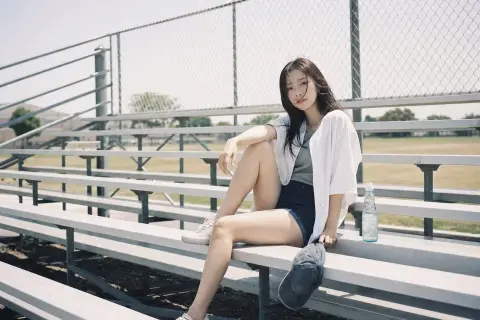 Touching film portrait of Korean idol at baseball stadium in summer afternoon